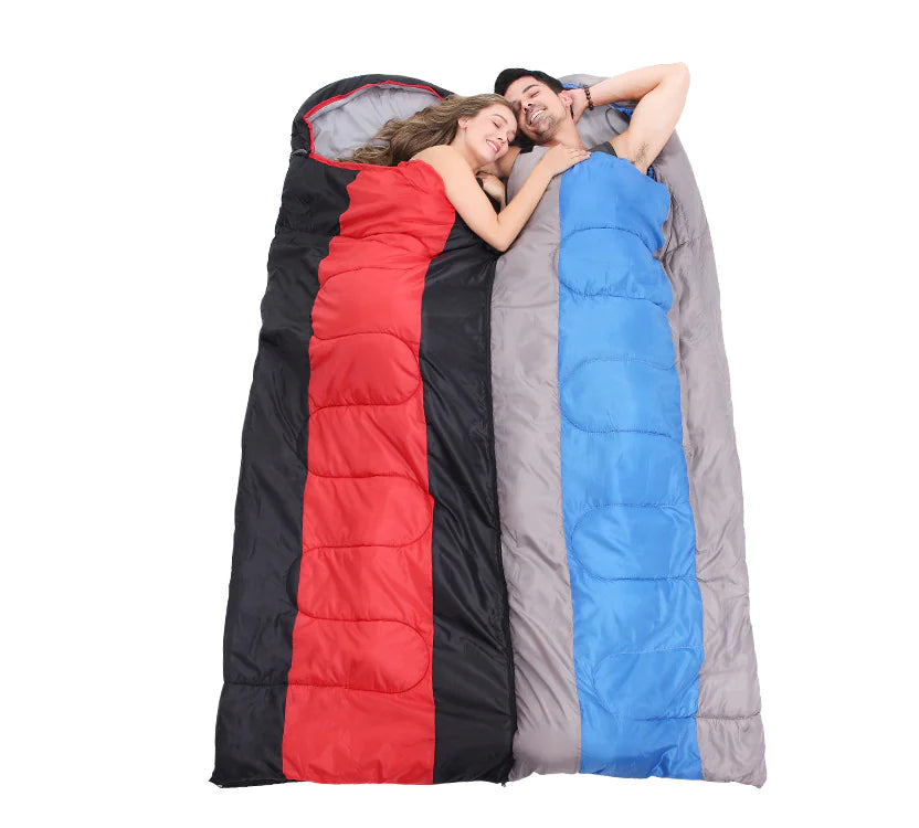 Two people lying in red, gray, and blue sleeping bags on a white background