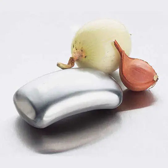 Silverdevice the size and shape of bar of soap with an onion and shallot on a white background called oder be gone that helps eliminate food prep oders