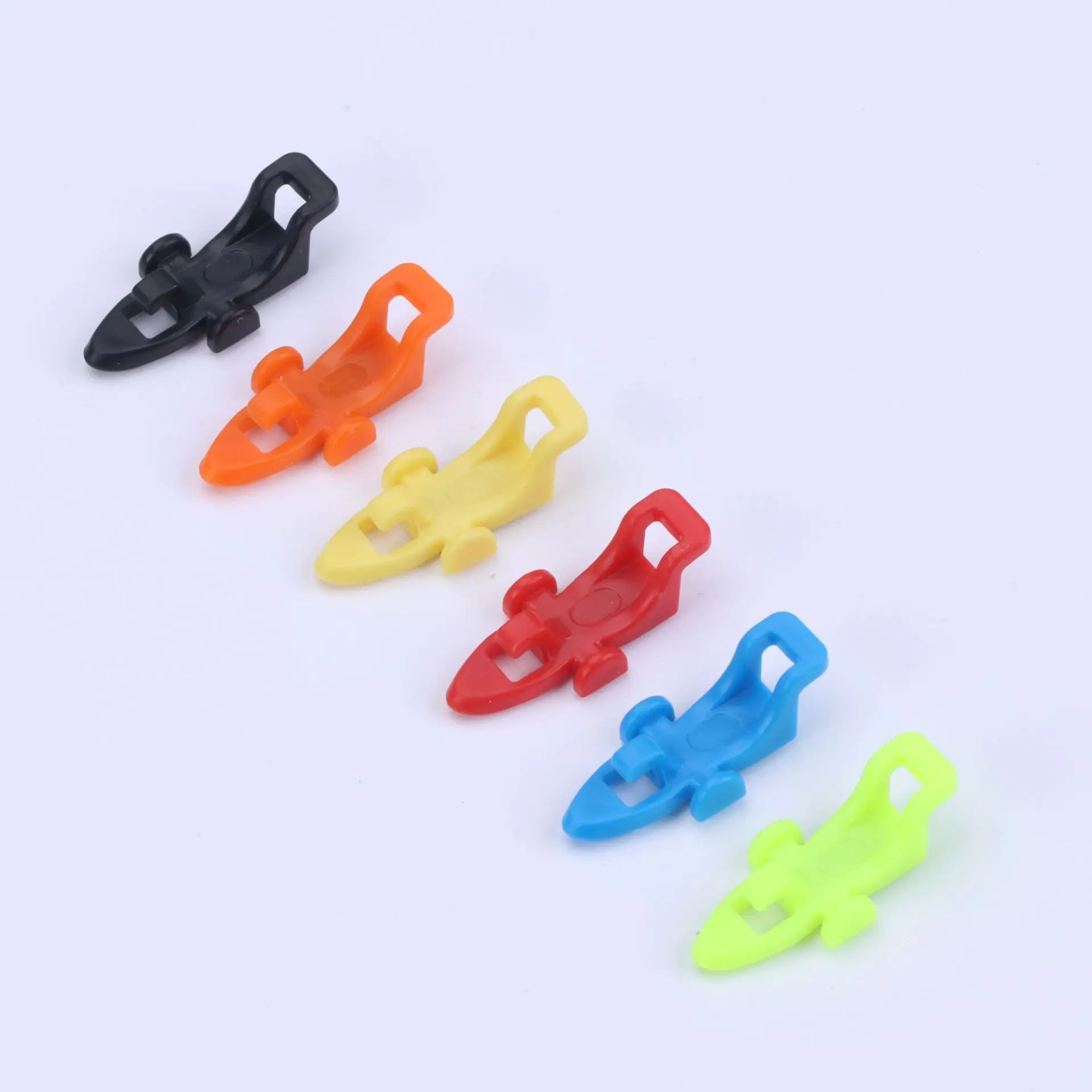 Set of colorful plastic bait hangers for fishing pole on a white background