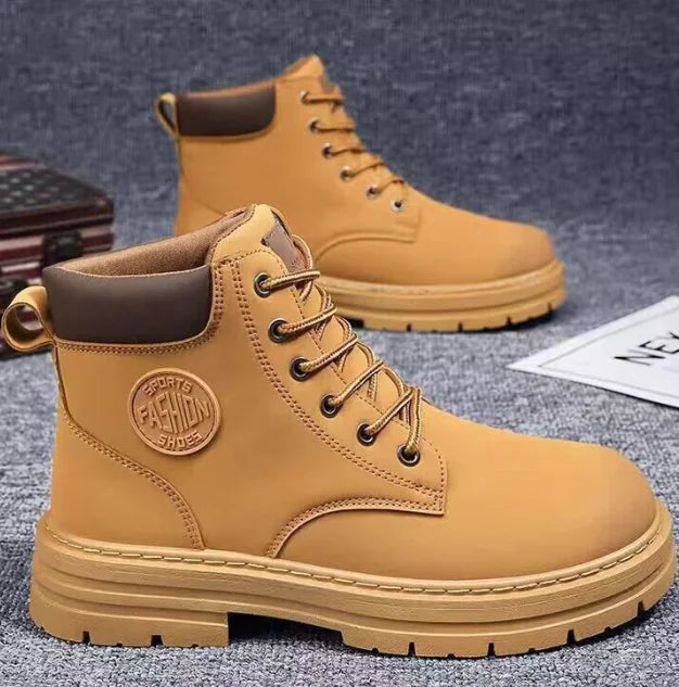 Tan boots with brown accents on a textured surface