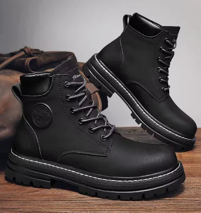 Black leather boots with a brand logo on a wooden surface