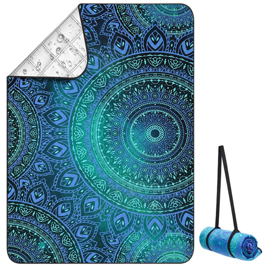 Picnic blanket with blue and green mandala design on a white background