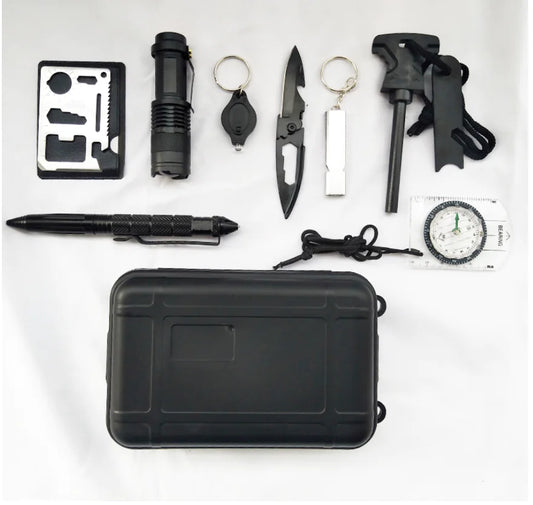 Collection of black survival tools including a knife, flashlight, and multitool on a white background.