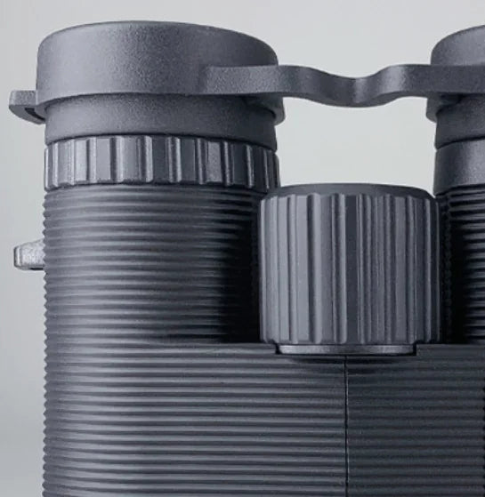 Close-up of a pair of binoculars on a light gray background