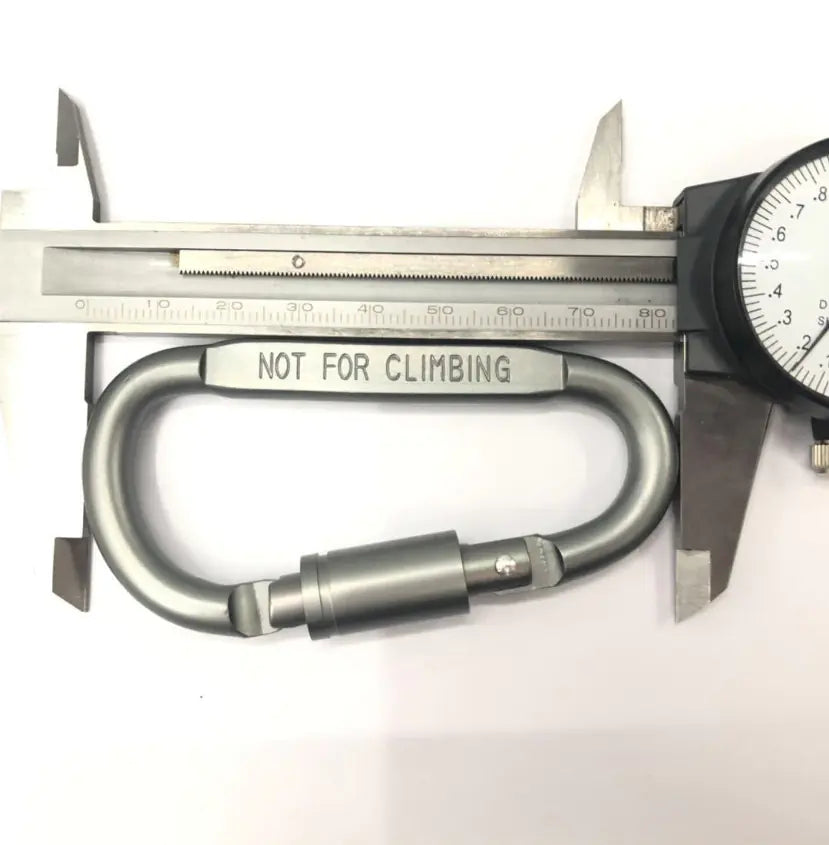 Metal carabiner with 'Not for Climbing' label being measured by a caliper on a white background