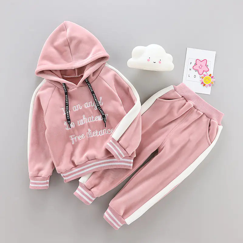 Pink children's hoodie and pants set on a gray background