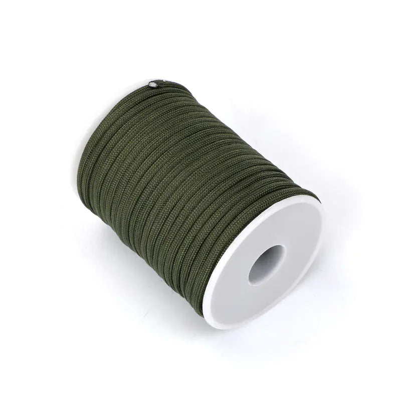 Spool of green thread on a white background