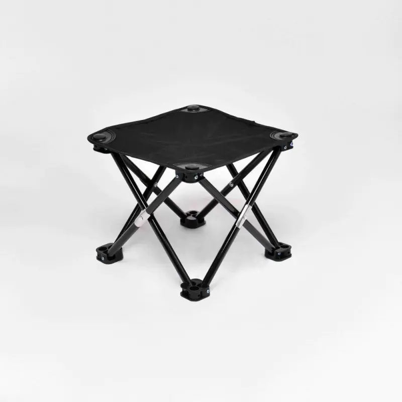 Black folding stool on a white background