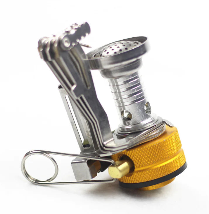 mini Portable camping stove with gold base and silver top on a white background