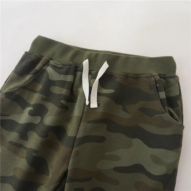 Camouflage pants with a white drawstring on a light gray background