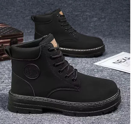 Black boots with a brand logo on a gray background