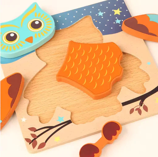 Wooden owl puzzle with colorful pieces on a white background