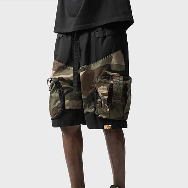 Camouflage cargo shorts with black accents on a white background