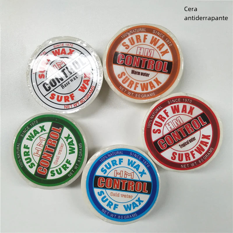 Five containers of surf wax with different colored labels on a white background.