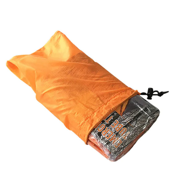 Orange sleeping bag folded up and displayed half pulled out of its carrying cover