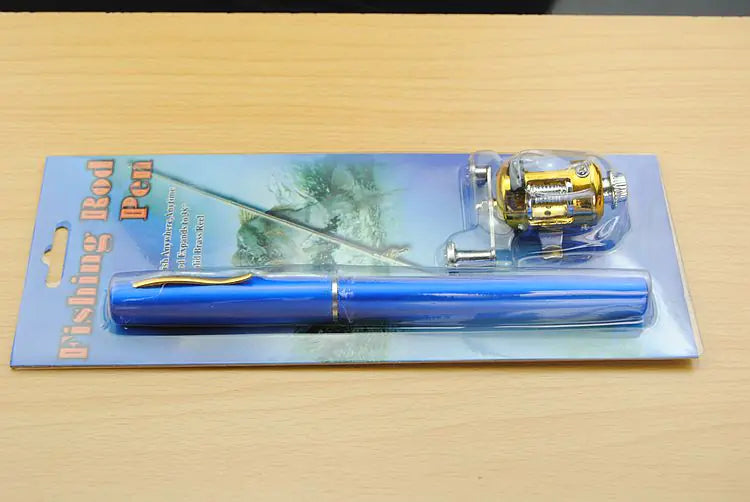 Fishing rod pen set with gold reel on a blue card packaging against a wooden surface.