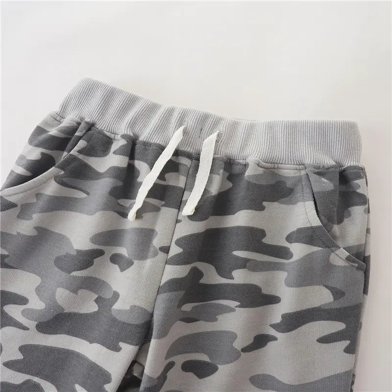 Gray camouflage shorts with drawstring on a light gray background