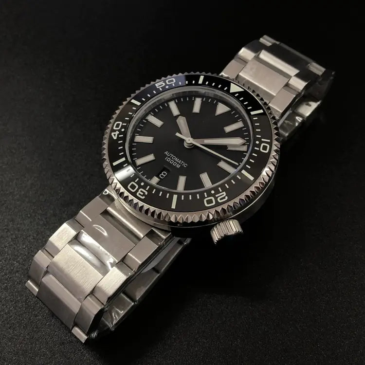 Stainless steel diving watch with black dial on a dark background