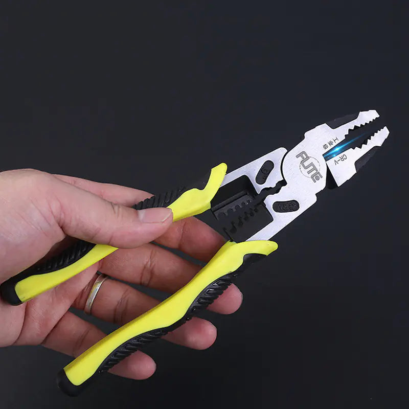 Hand holding a pair of multifunction pliers with yellow handles against a black background