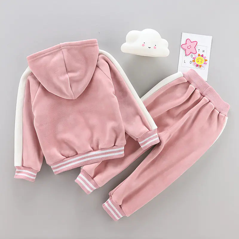 Pink children's tracksuit with a cloud and card on a gray background
