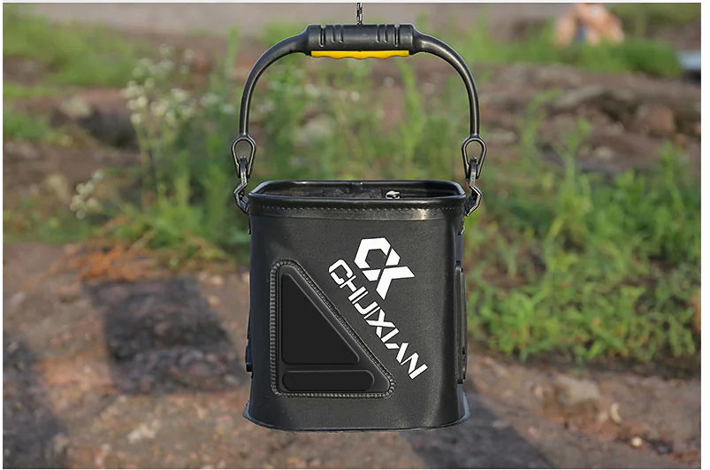 Black Chuxian branded fishing water bucket on a natural outdoor background