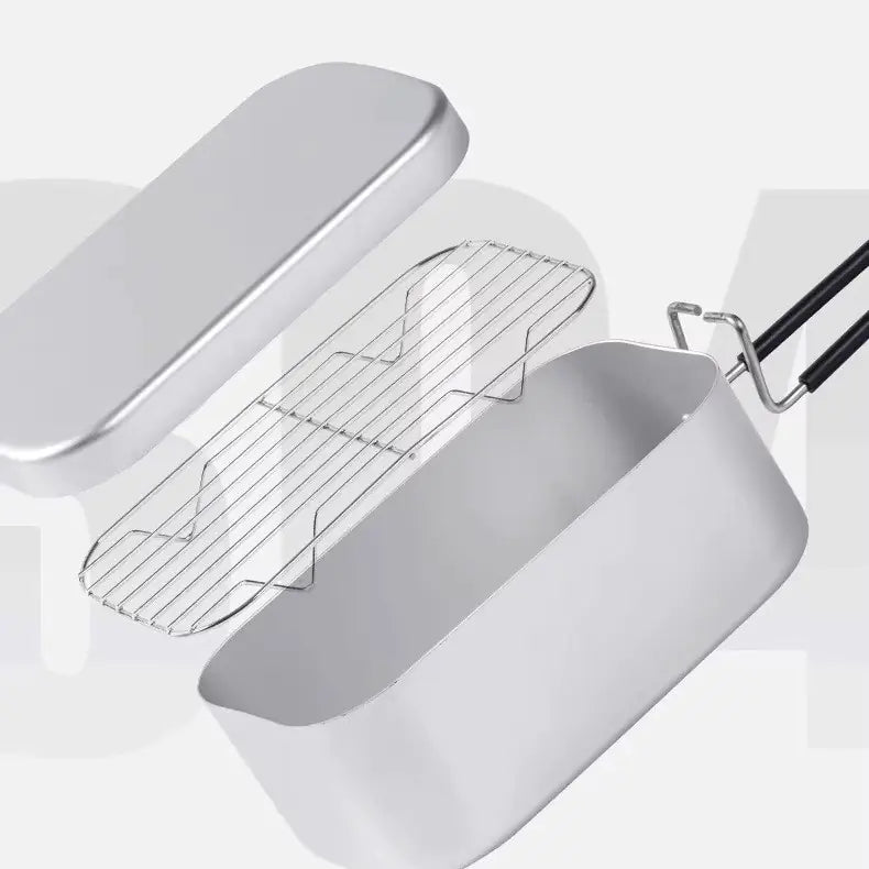 German cooking box open showing steamer grid and lid, has black handle on end