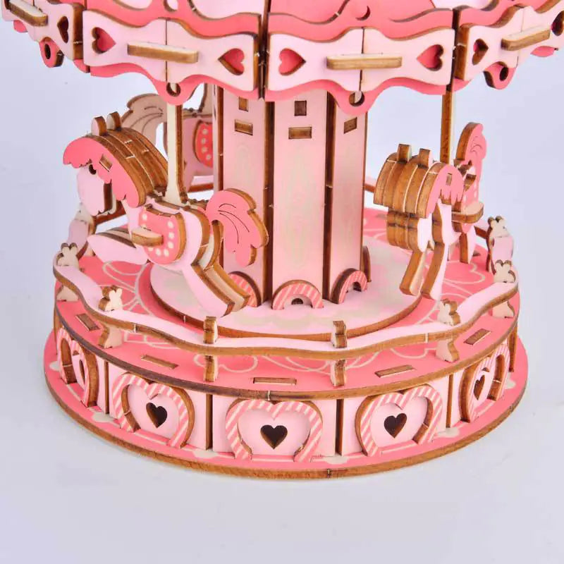 Close up view of Pink carousel 3d puzzle kit with horses that runs on  AAA batteries once constructed