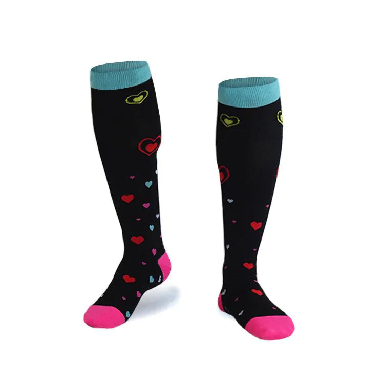 Black knee-high  compression socks with colorful heart patterns and light blue cuffs on a white background