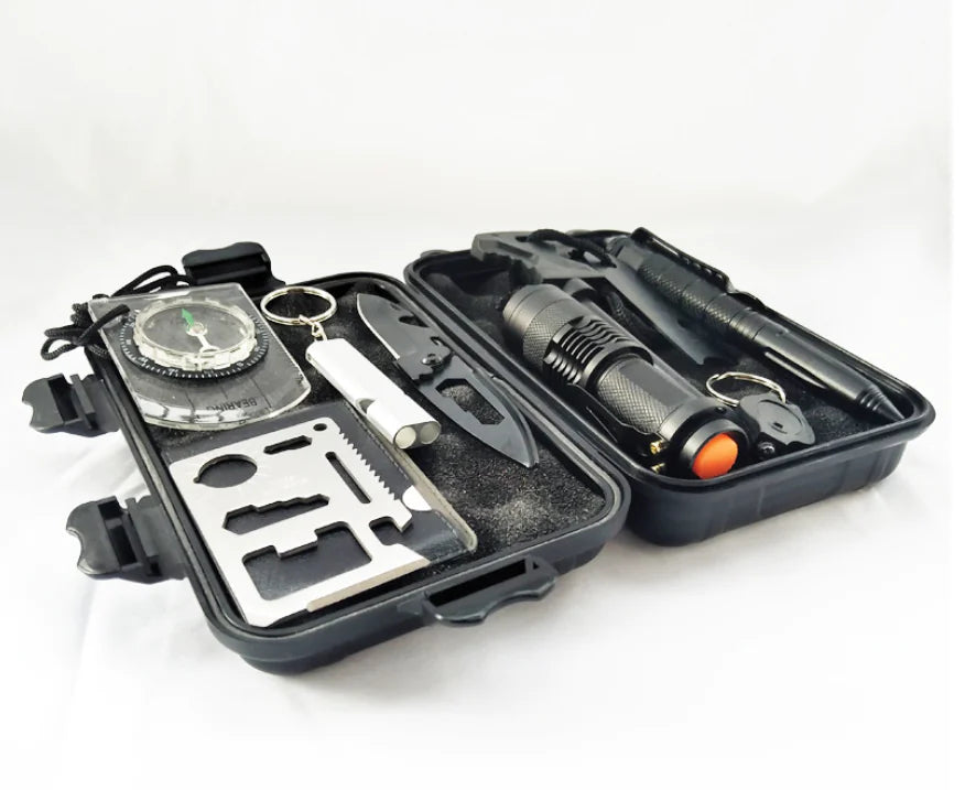 Black survival kit with tools and flashlight on a white background