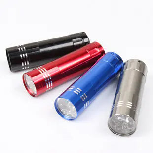 Four  mini LED flashlights in black, red, blue, and silver on a white background