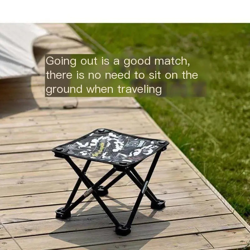 Foldable stool on a wooden deck with grass in the background