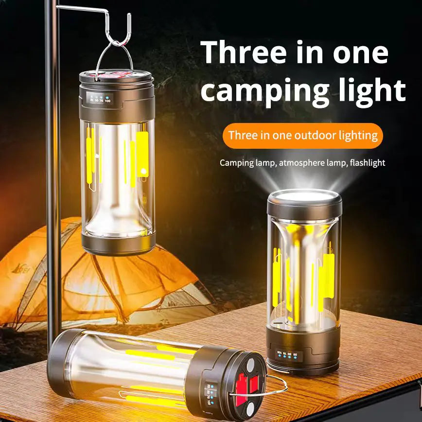 Three-in-one camping light with lantern, lamp, and flashlight functions on a wooden surface.