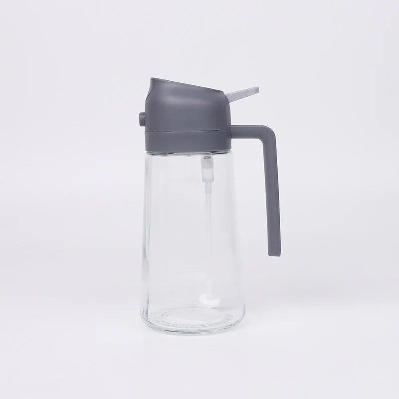 Clear glass bottle with a gray lid and handle on a white background