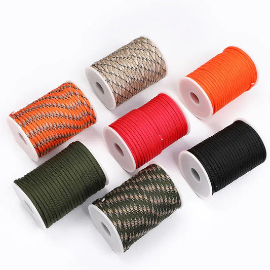 Set of spools with various colored paracords on a white background