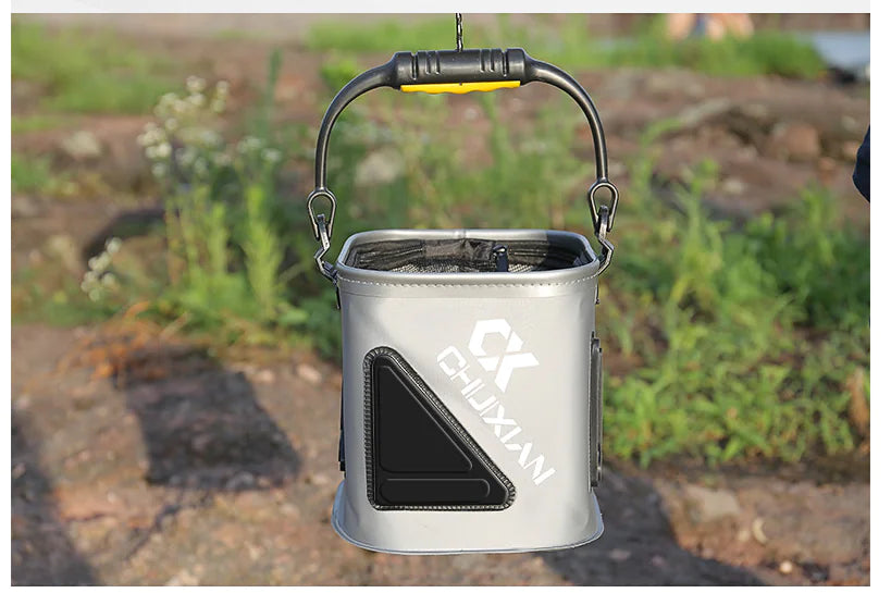 Grat Portable water  fishing bucket with handle on a natural background