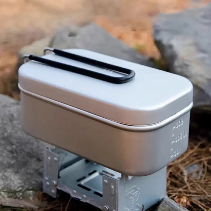 Portable stove with German cooking box with a lid on a natural background