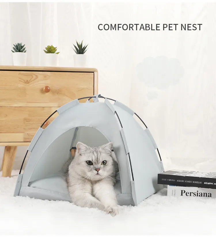 Cat lying inside a grey pet cooling tent with a wooden dresser and books in the background