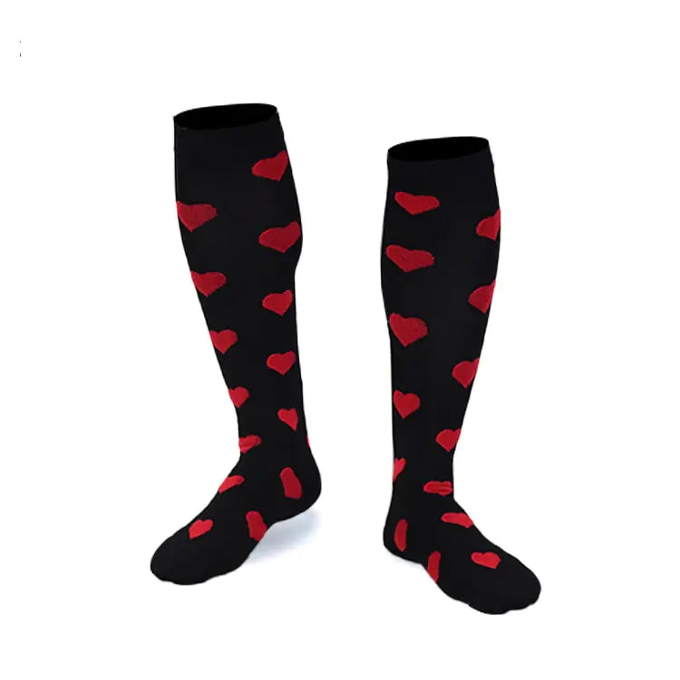 Black knee-high compression socks with red heart patterns on a white background