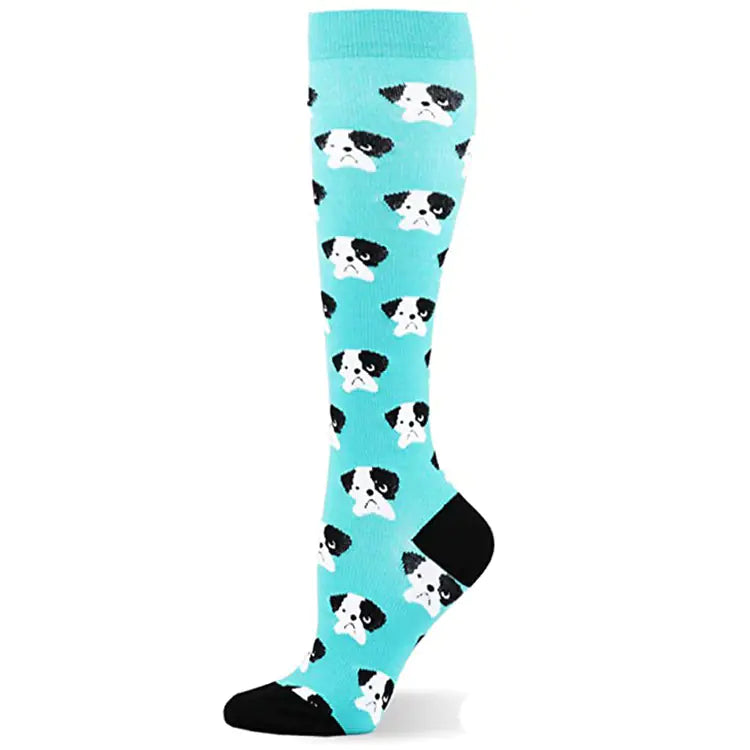 Knee-high compression sock with dog pattern on a light blue background
