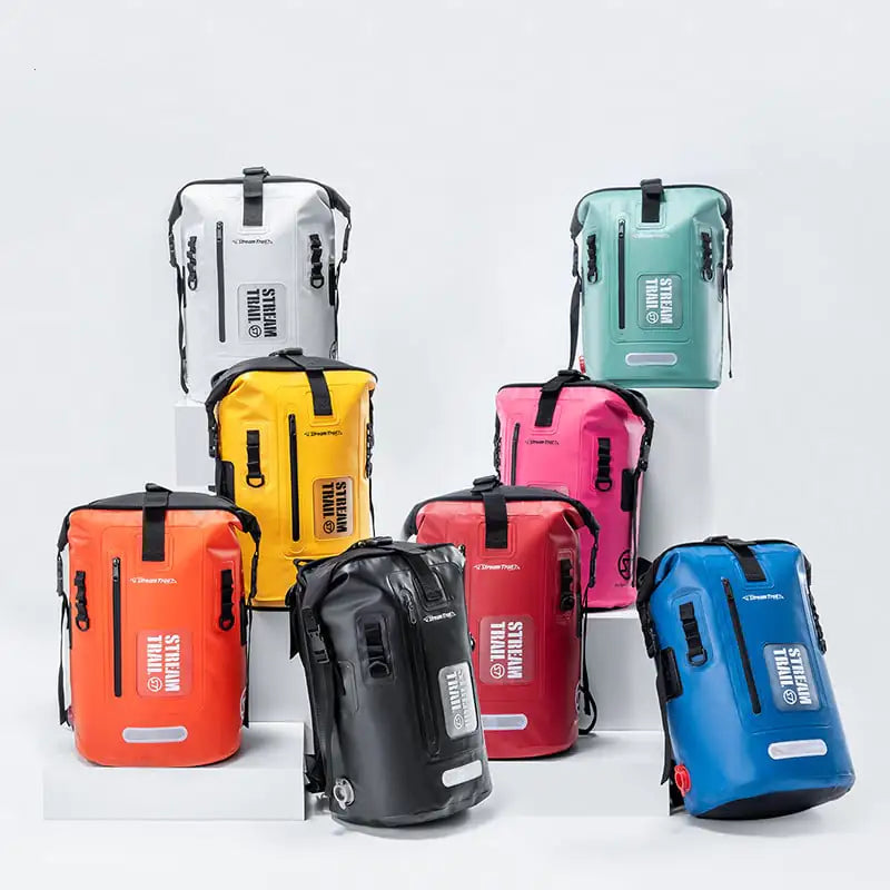 Collection of colorful waterproof diving backpacks on a white background