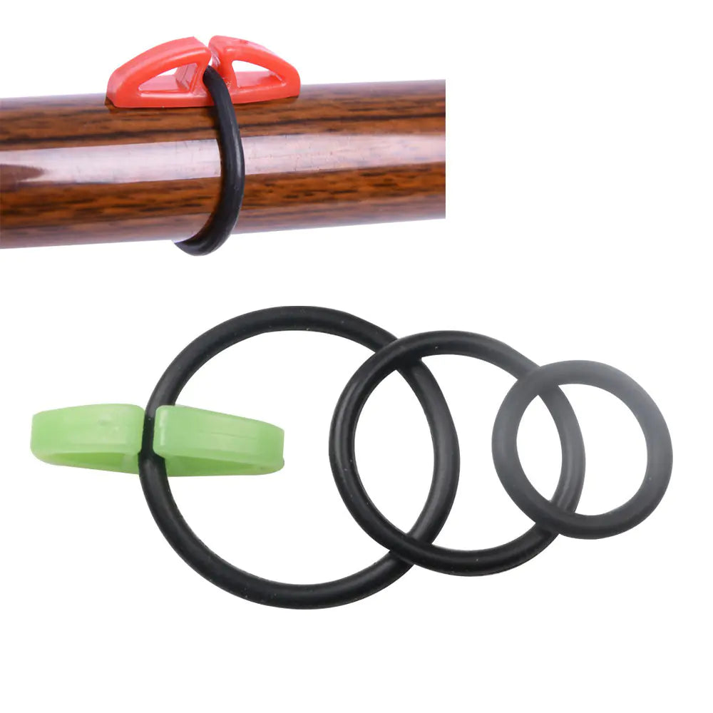 Set of black rubber bands with green and red bait hanger clips on a white background