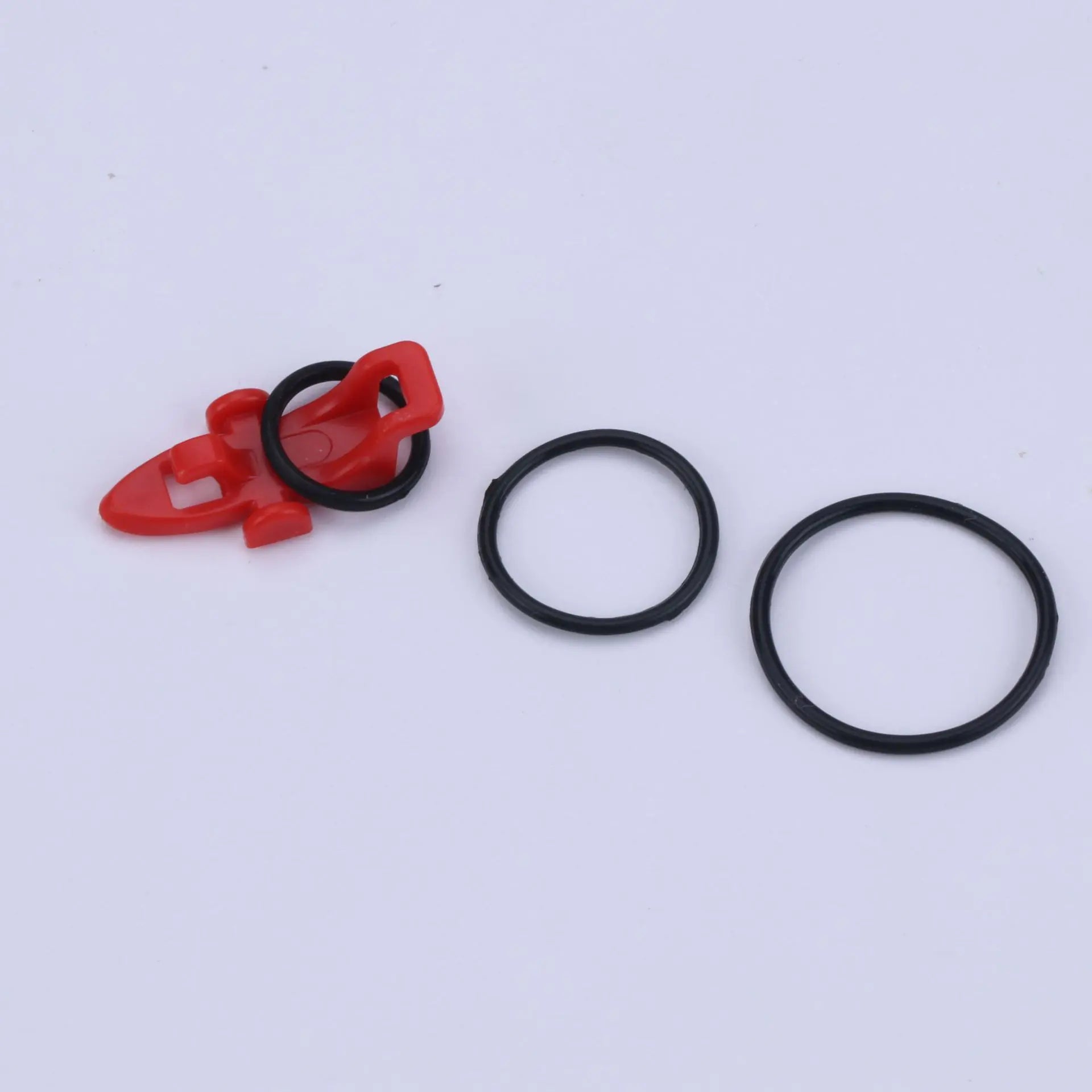 Red plastic bait hanger for fishing pole on a white background