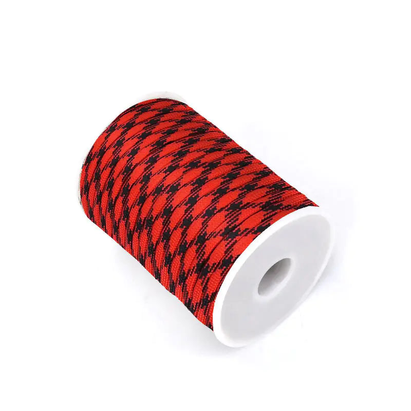 Roll of red and black patterned tape on a white background