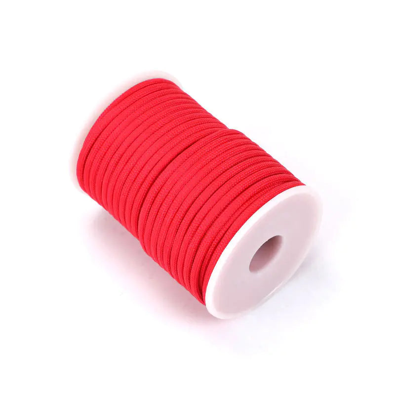 Spool of red elastic thread on a white background