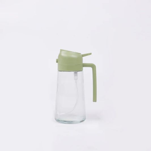 Clear glass bottle with a green lid and handle on a white background