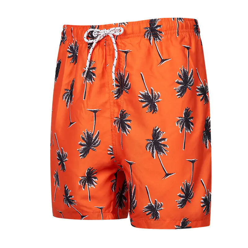 Orange swim shorts with black palm tree pattern on a white background