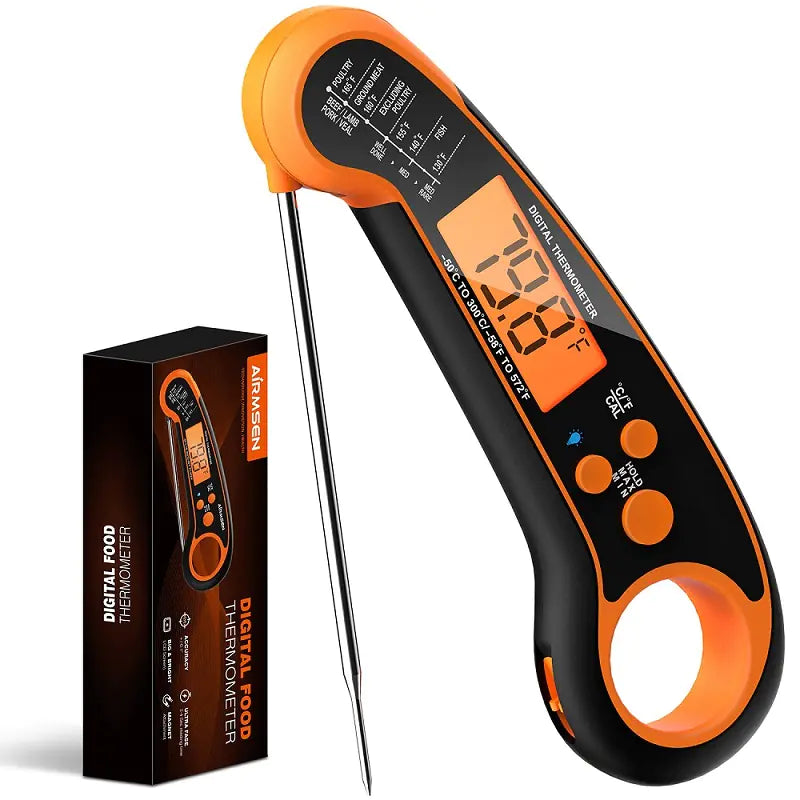 Digital food thermometer with orange and black design, displayed with its packaging on a white background.