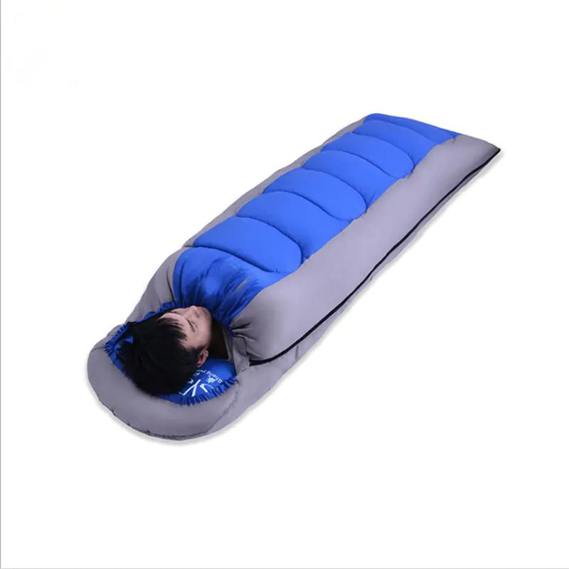 Person lying in a blue and gray sleeping bag on a white background