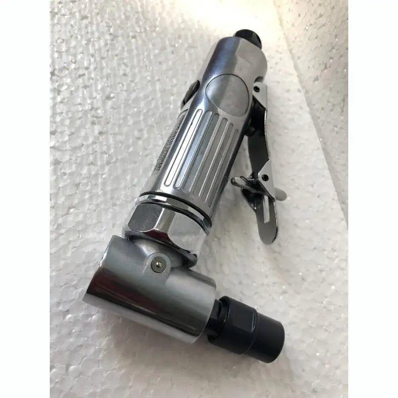 Pneumatic air grinder tool on a textured white surface