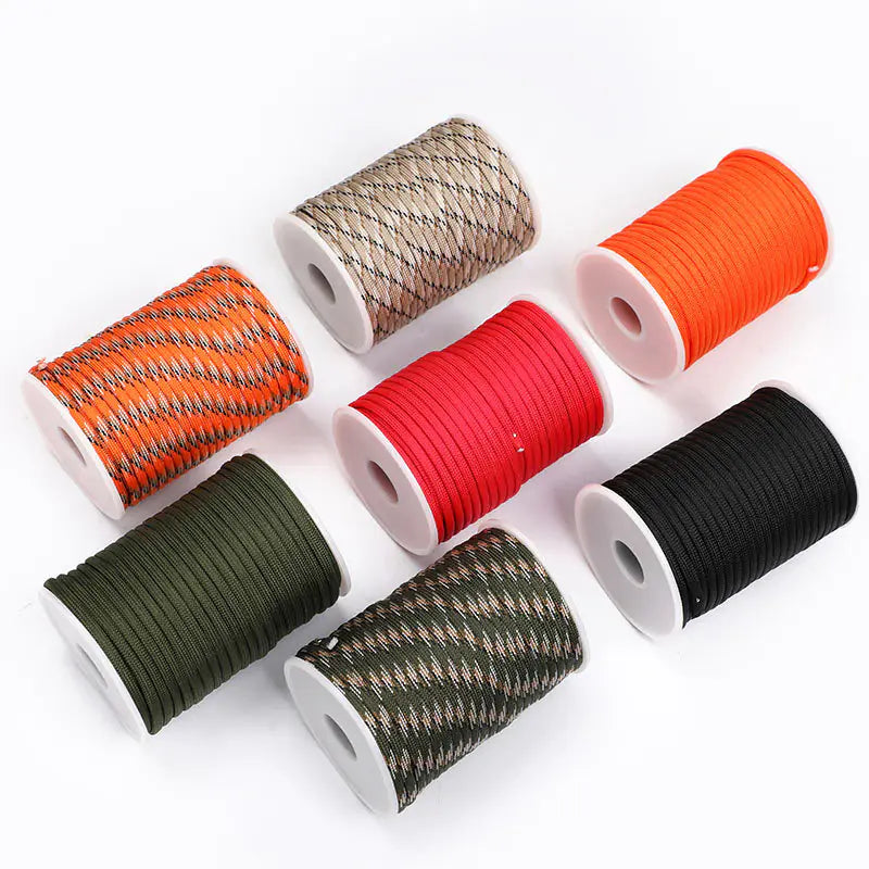 Set of spools with various colored paracords on a white background
